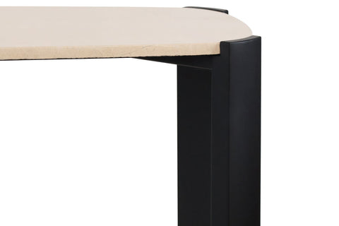 Cream marble top with subtle veining rests on a sleek black acacia wood frame, showcasing rounded corners and a modern design.