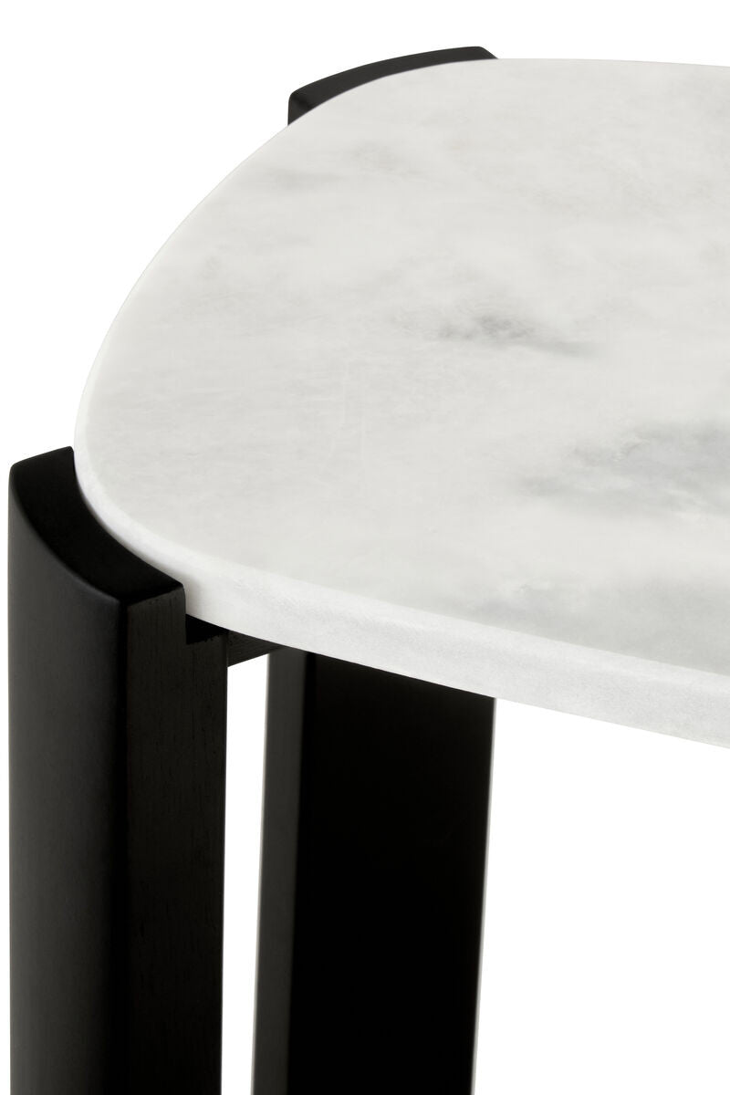 Close-up view of a console table featuring a smooth white marble top with subtle gray veining, complemented by sleek black acacia wood legs.