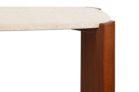 Cream travertine top with a textured surface, complemented by sturdy brown acacia wood legs. The table features rounded edges and a sleek design, ideal for modern interiors.