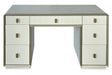 Cream-colored dressing table featuring seven drawers with a mix of smooth and ribbed fronts. The table has a sleek design with a subtle metallic trim and round handles.