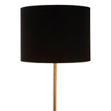 Black drum lampshade on gold metal floor lamp, close up against white background