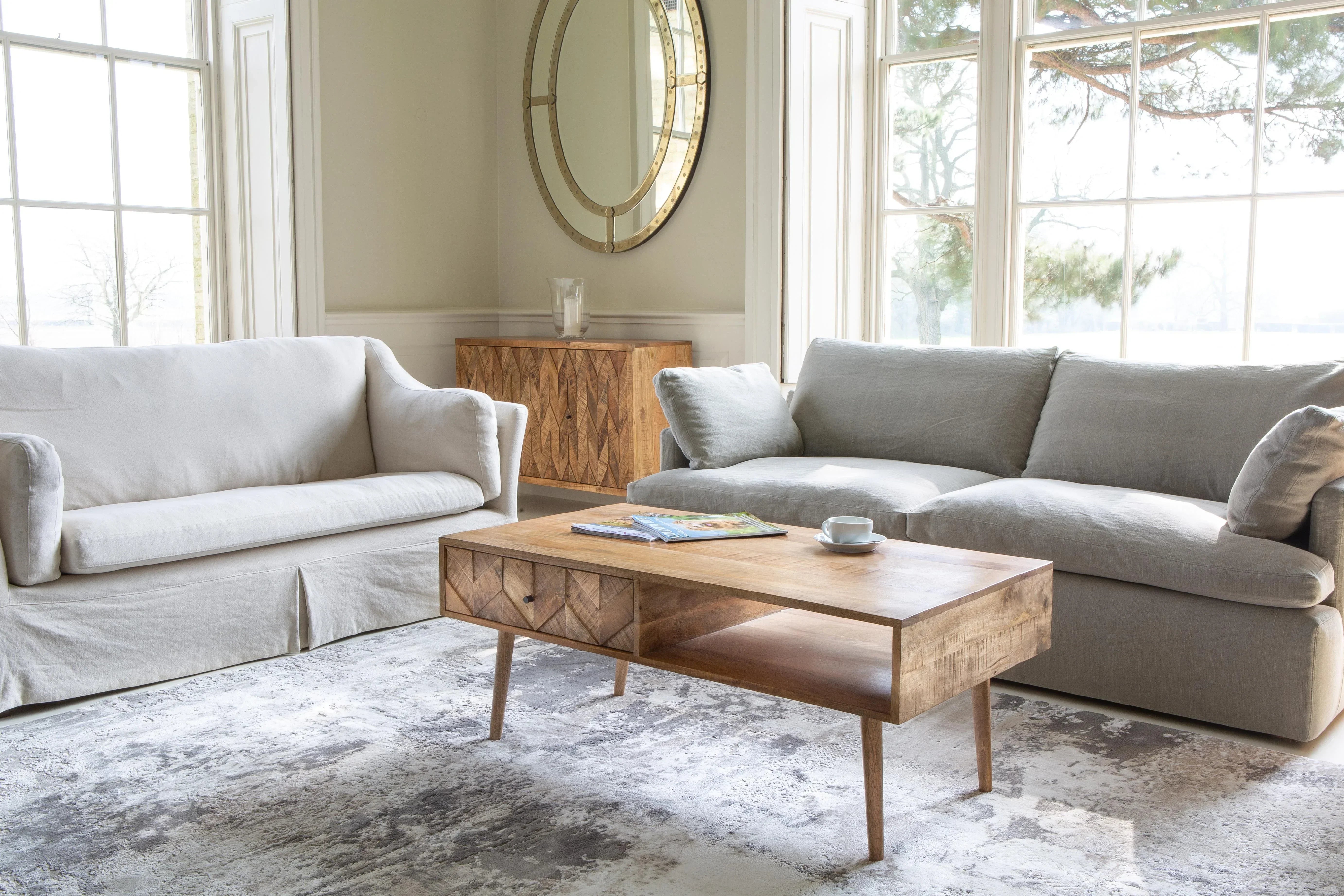 Light oak coffee table with storage shelf and drawers in modern living room setting