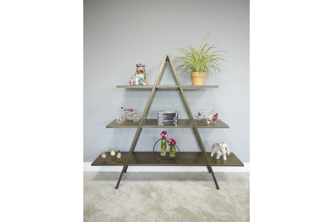 Three-tier metal display shelves in an A-frame design with decorative items, against a gray wall.