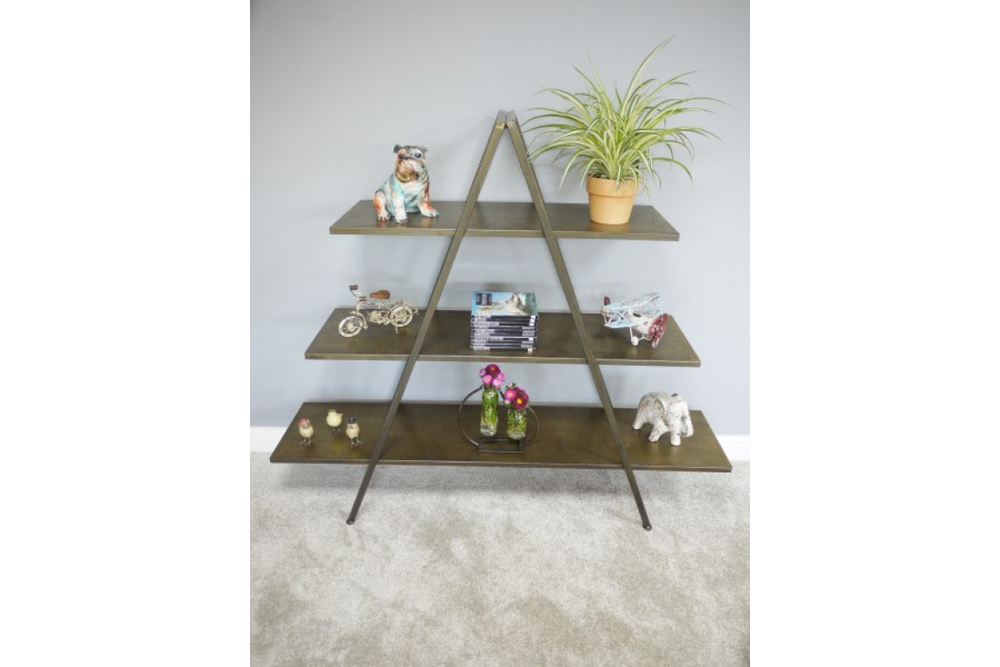 Three-tier A-frame display shelves in dark metal with decorative items, against a light grey wall and carpeted floor.