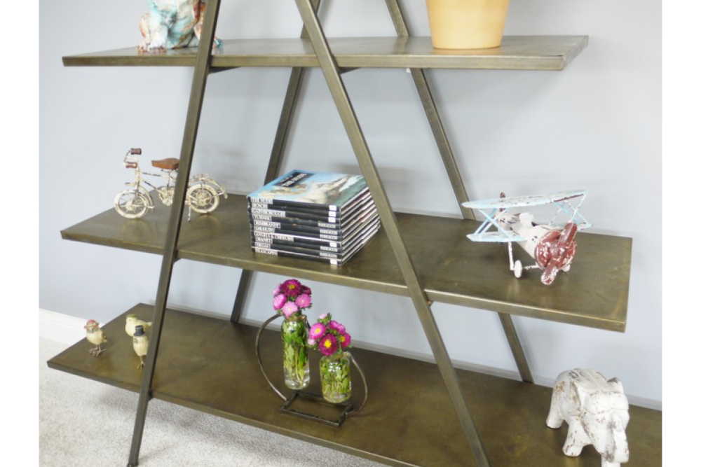 Triangular metal display shelves in bronze finish, shown angled with decorative items on three levels