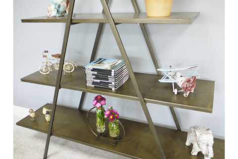 Triangular metal display shelves in bronze finish, shown angled with decorative items on three levels