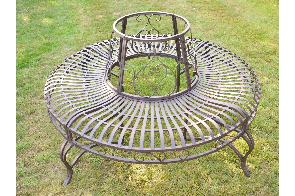 Brown metal tree bench with curved slats and decorative scrollwork on garden lawn