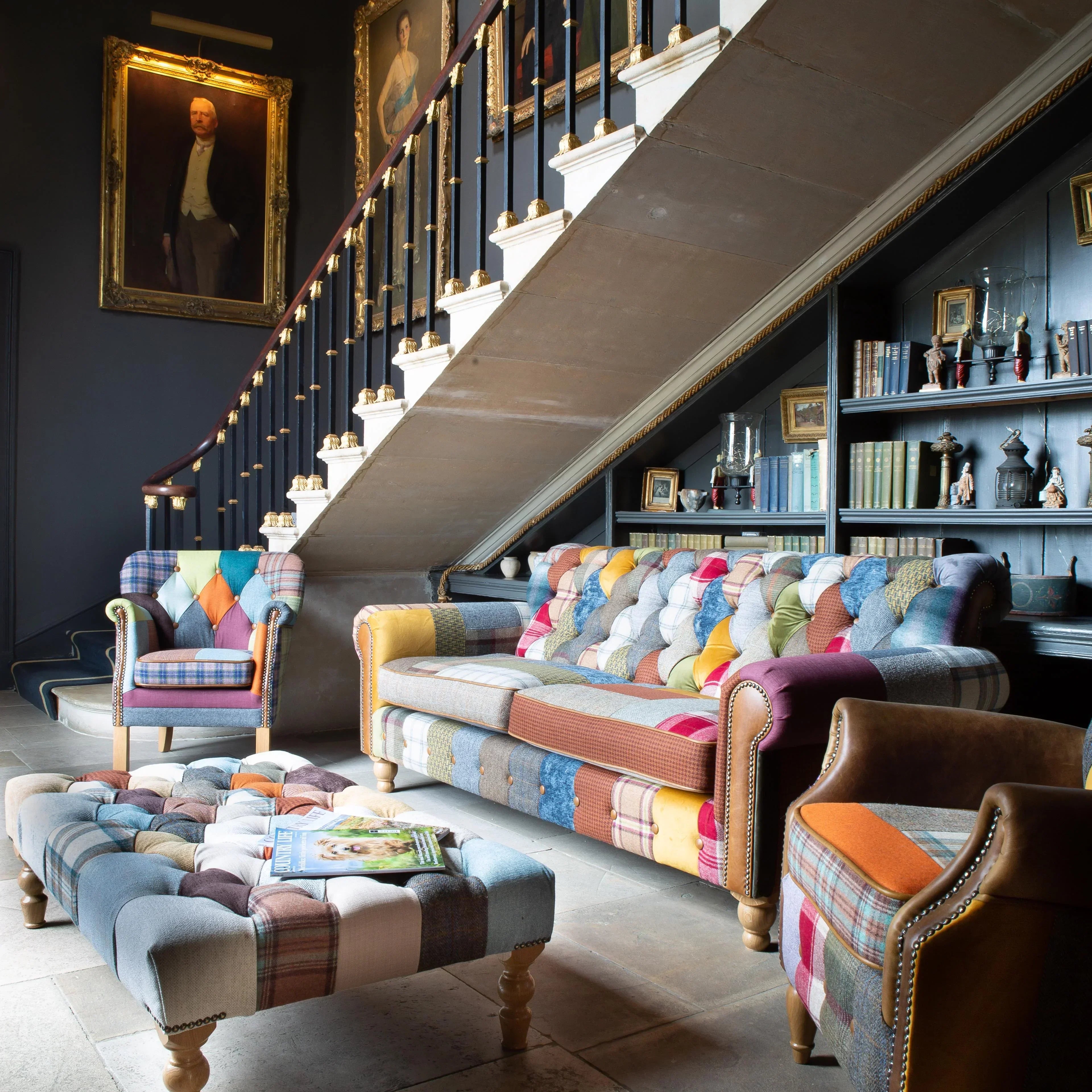 Patchwork fabric sofa set with armchairs and ottoman in a traditional living room setting