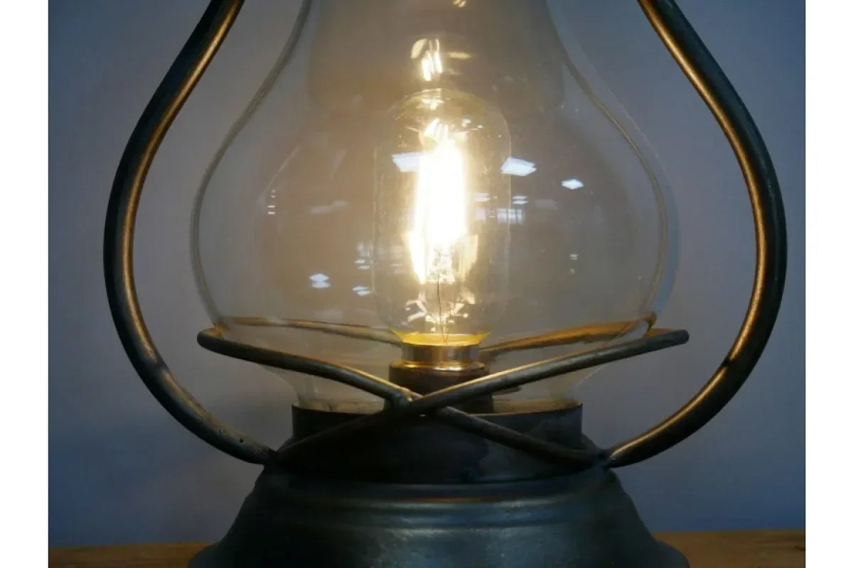 Vintage style glass table lamp with exposed lightbulb and metal frame