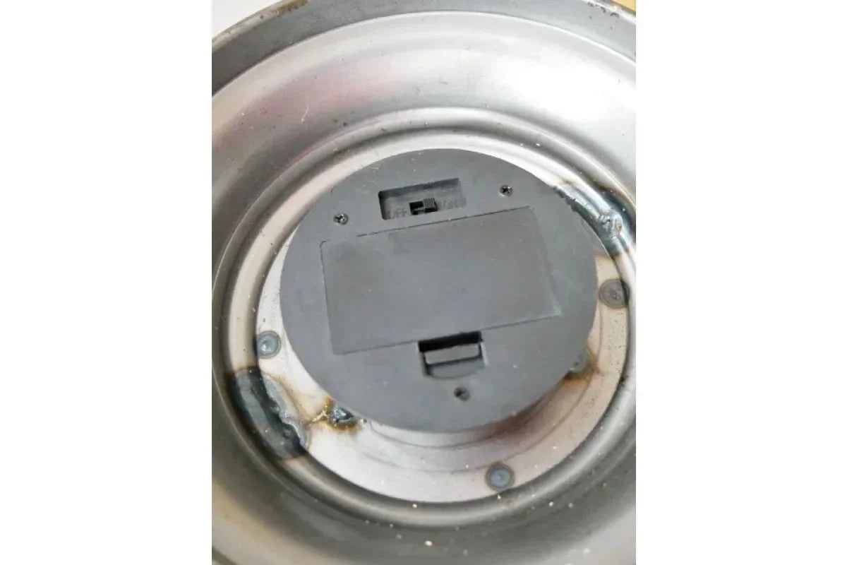 Close-up of metal base with battery compartment and on off switch for home décor accessory