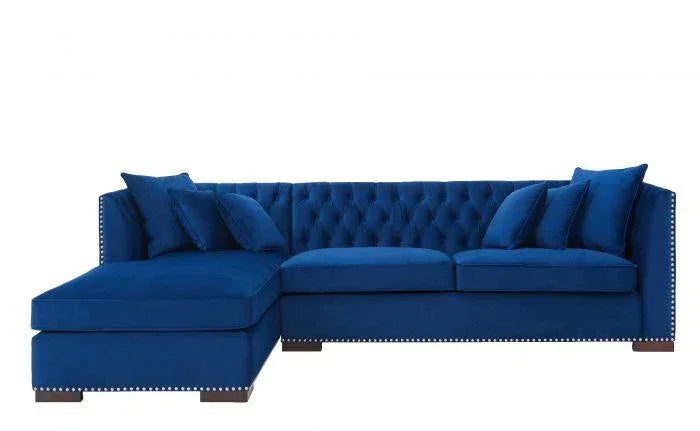 Blue velvet corner sofa with tufted back, studded trim, and matching scatter cushions