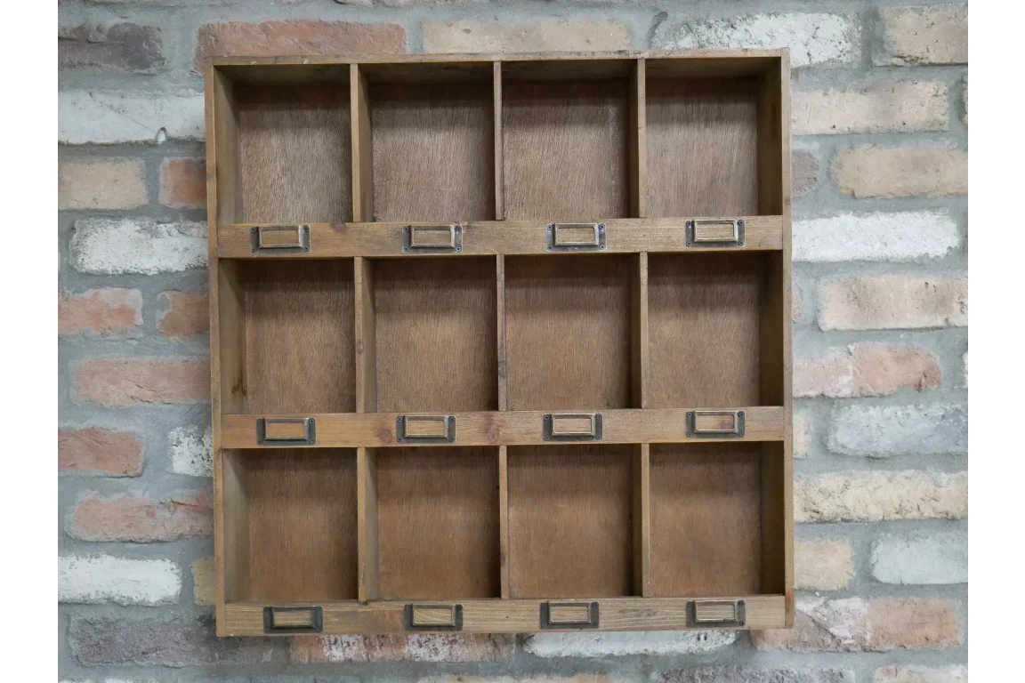 Wooden wall shelf unit with 12 cubby compartments and label holders on exposed brick wall