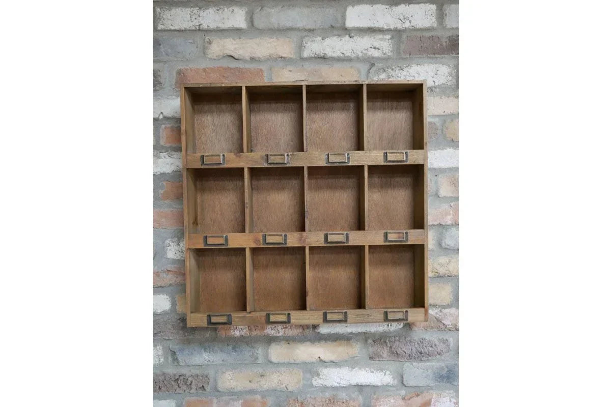 Wooden wall storage shelf with twelve cubby compartments against a brick wall