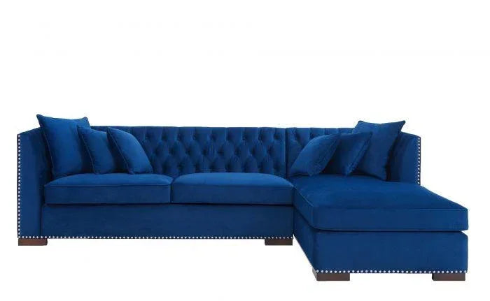 Blue velvet corner sofa with button-tufted back, stud detailing and matching cushions