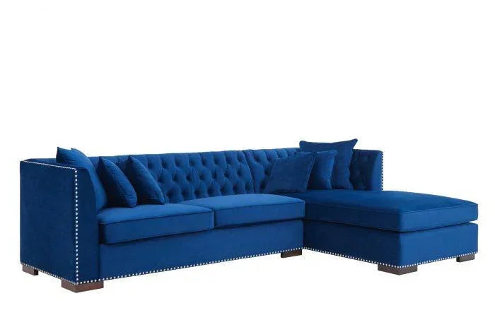 Blue velvet corner sofa with tufted back, stud detailing, and matching cushions