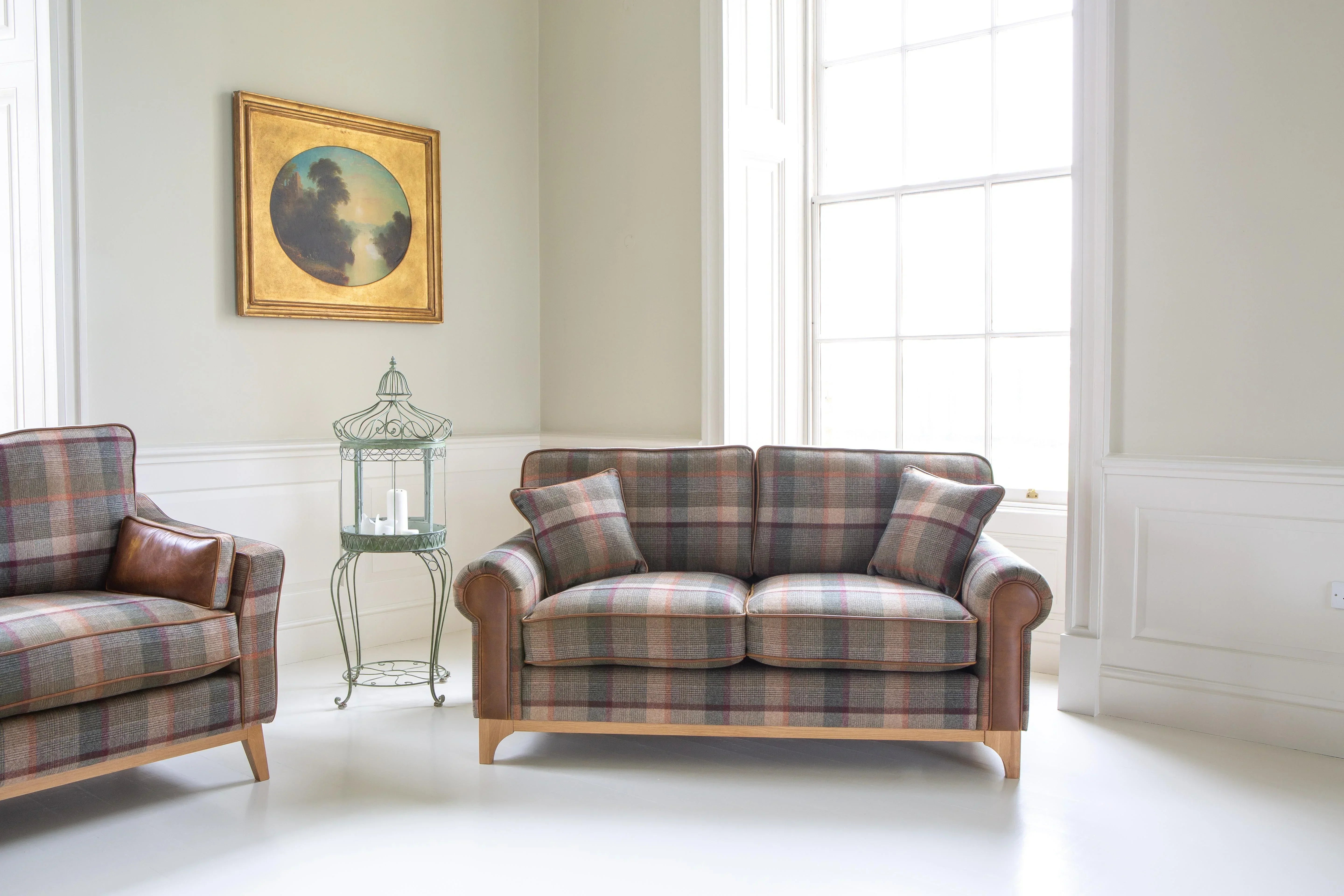 Plaid fabric sofa with wooden legs and cushions in a bright living room setting