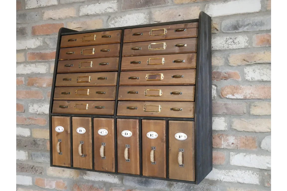 Wall-mounted wooden storage cabinet with labeled drawers and rope handles