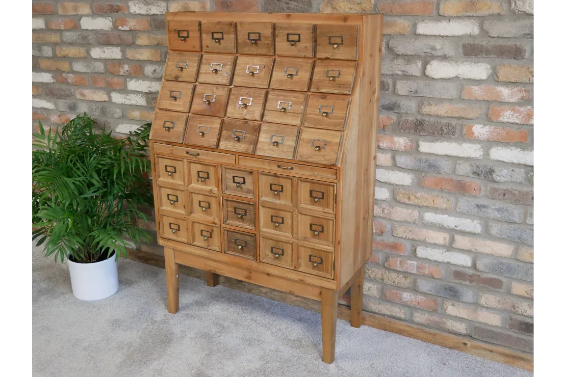Wooden apothecary cabinet with multiple storage drawers against brick wall