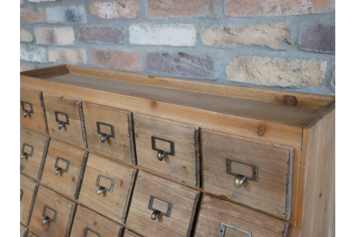 Rustic wooden chest of drawers with metal handles and vintage label holders