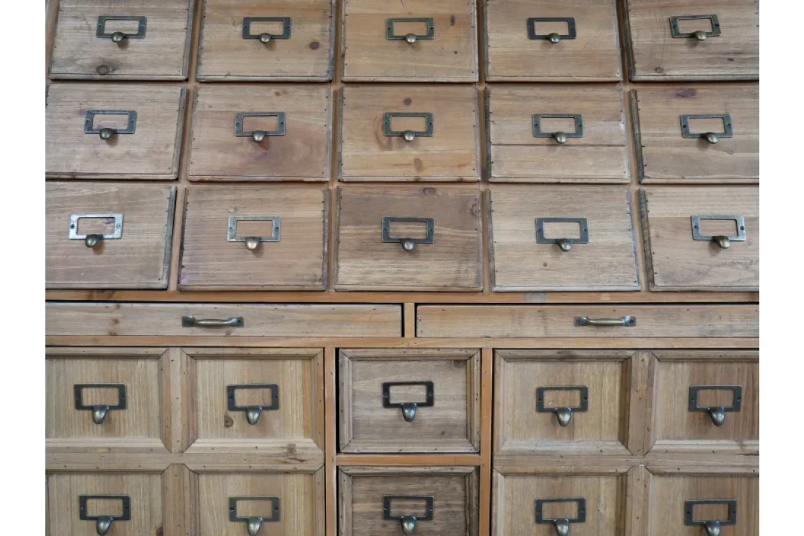 Natural wood storage cabinet with multiple drawers and metal handles, ideal for home organization
