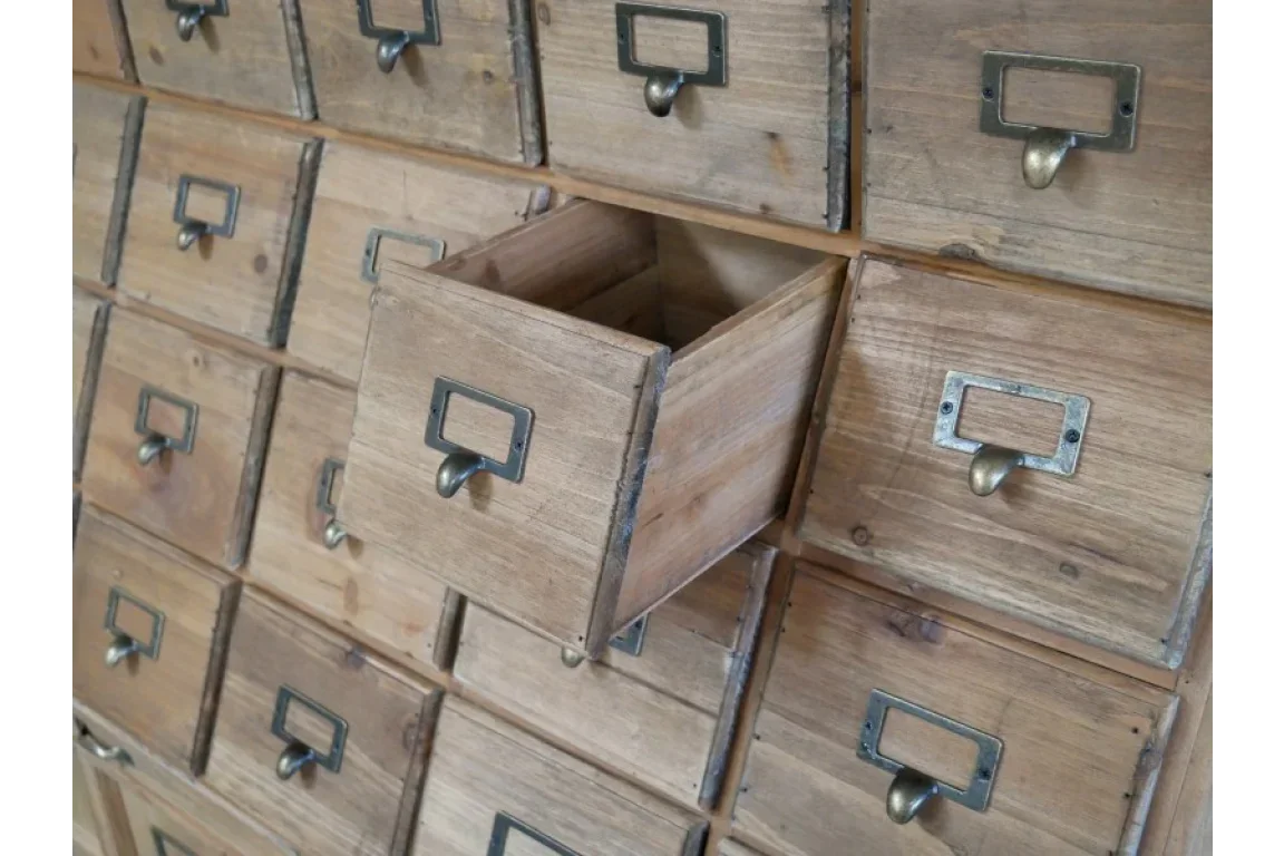 Rustic wooden storage cabinet with multiple drawers and metal handles, one drawer open