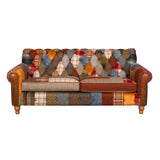 Patchwork fabric sofa with tufted backrest, wooden legs and studded arm details
