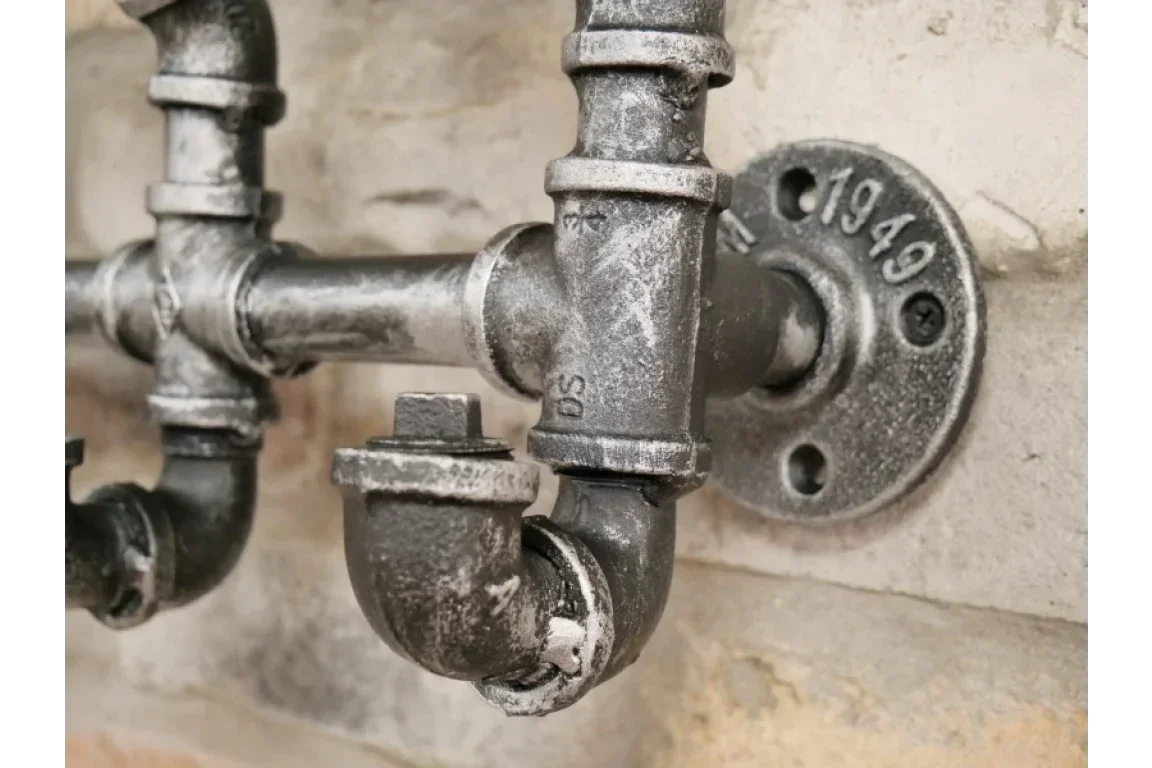 industrial metal pipe fitting wall decor with black finish and rustic details