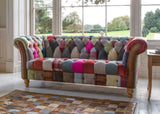 Patchwork fabric sofa with button detailing and wooden legs in a bright living room