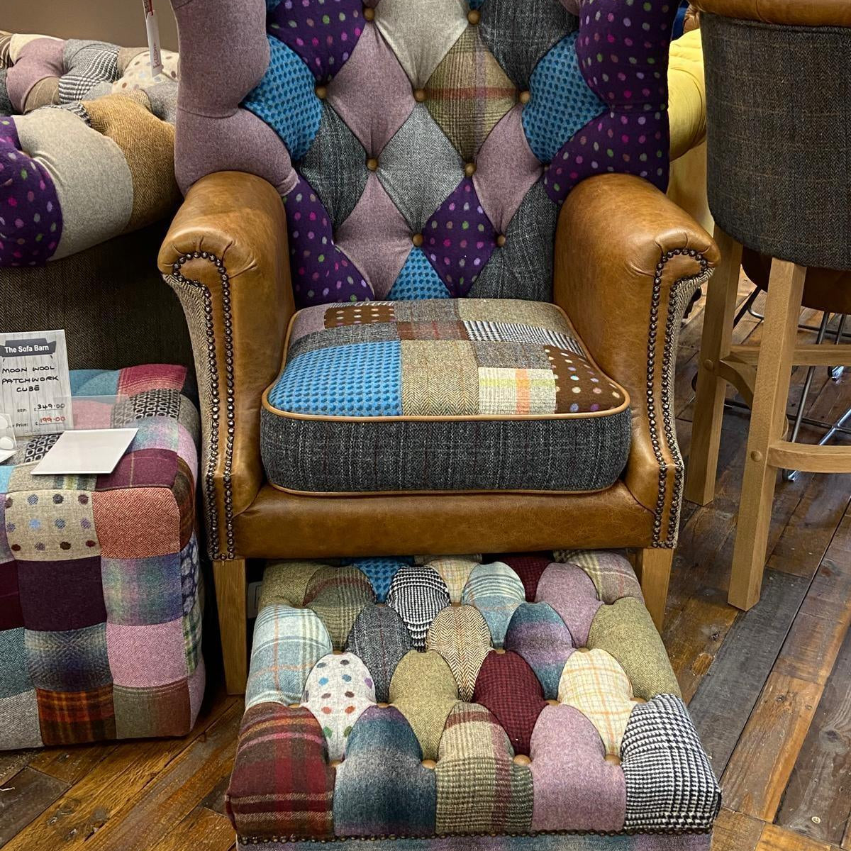 Patchwork armchair with leather arms and matching footstool on wooden floor