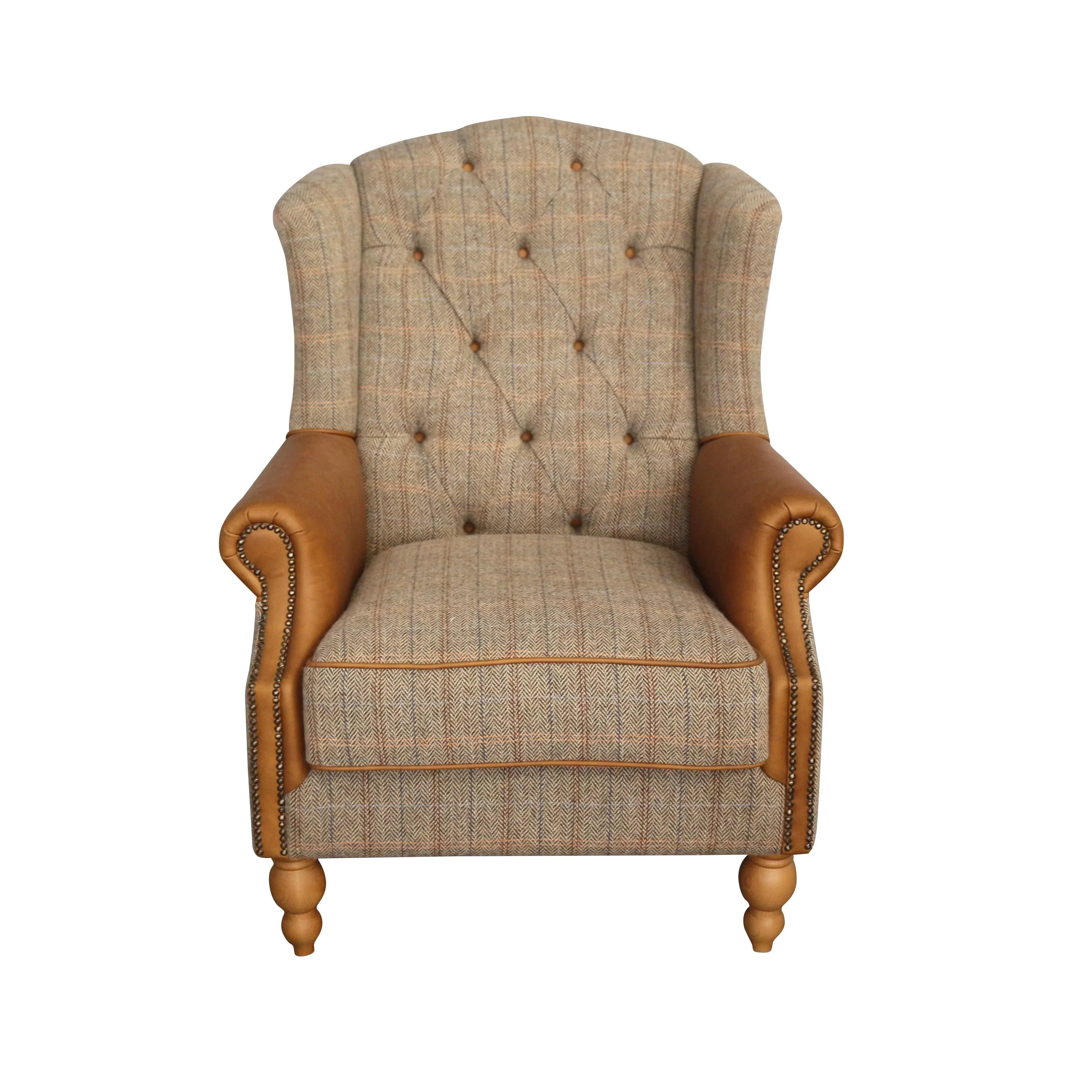 Plaid fabric armchair with button-tufted back, tan leather arms, and wooden legs