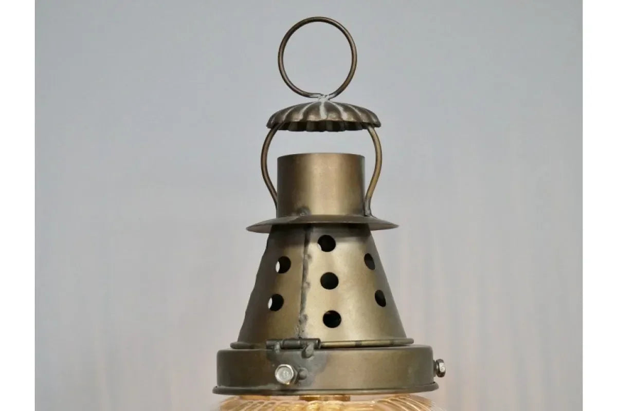 Brass pendant light fixture with perforated metal shade and round hanging loop