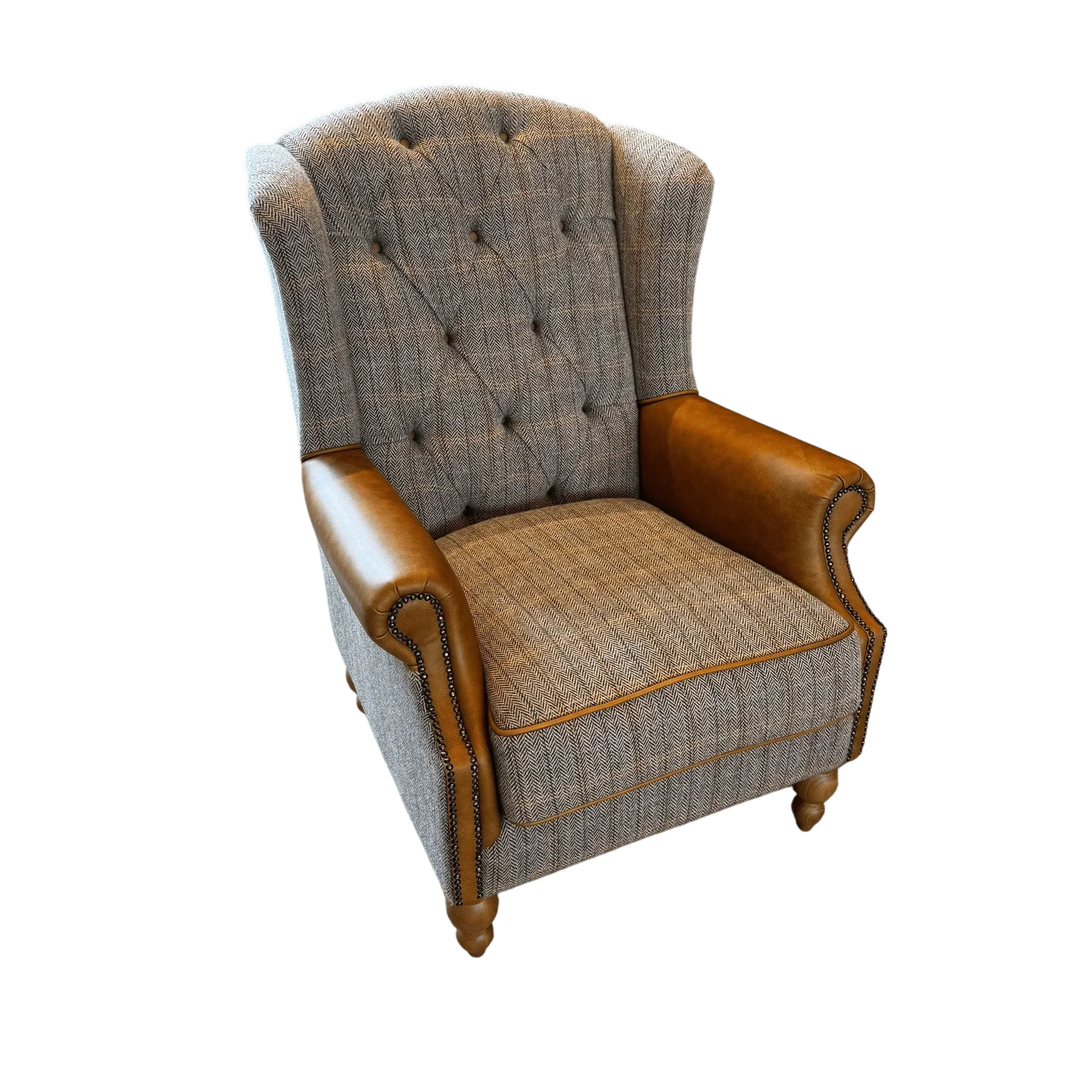 Grey fabric armchair with button-tufted back and tan leather rolled arms