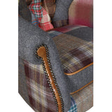 Patchwork armchair with multicolored fabric, studded brown trim, and tweed upholstery detail