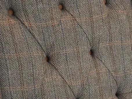 Tufted herringbone fabric upholstery with button detail on furniture backrest