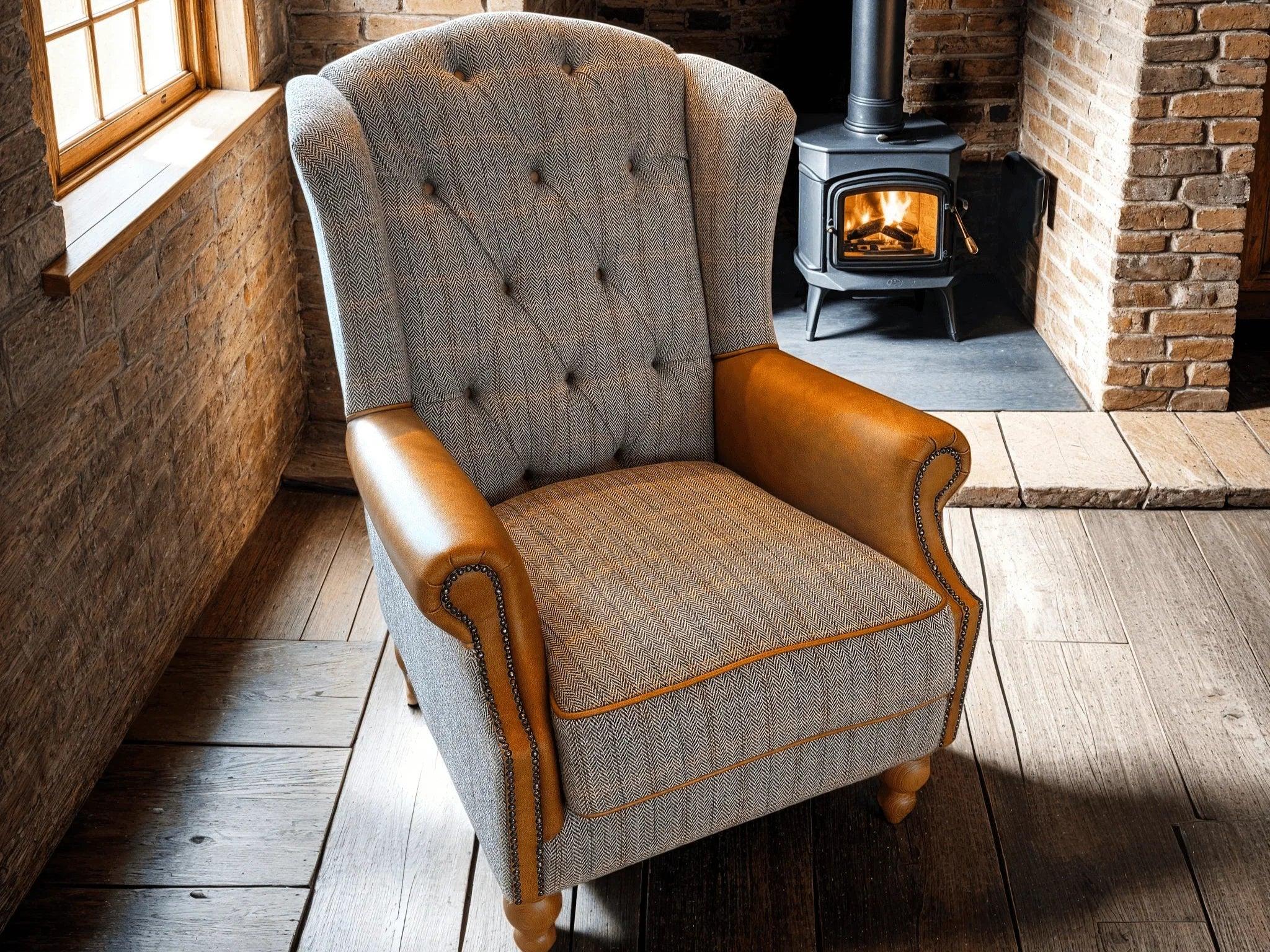 Button tufted armchair with herringbone fabric and tan leather arms in rustic lounge setting