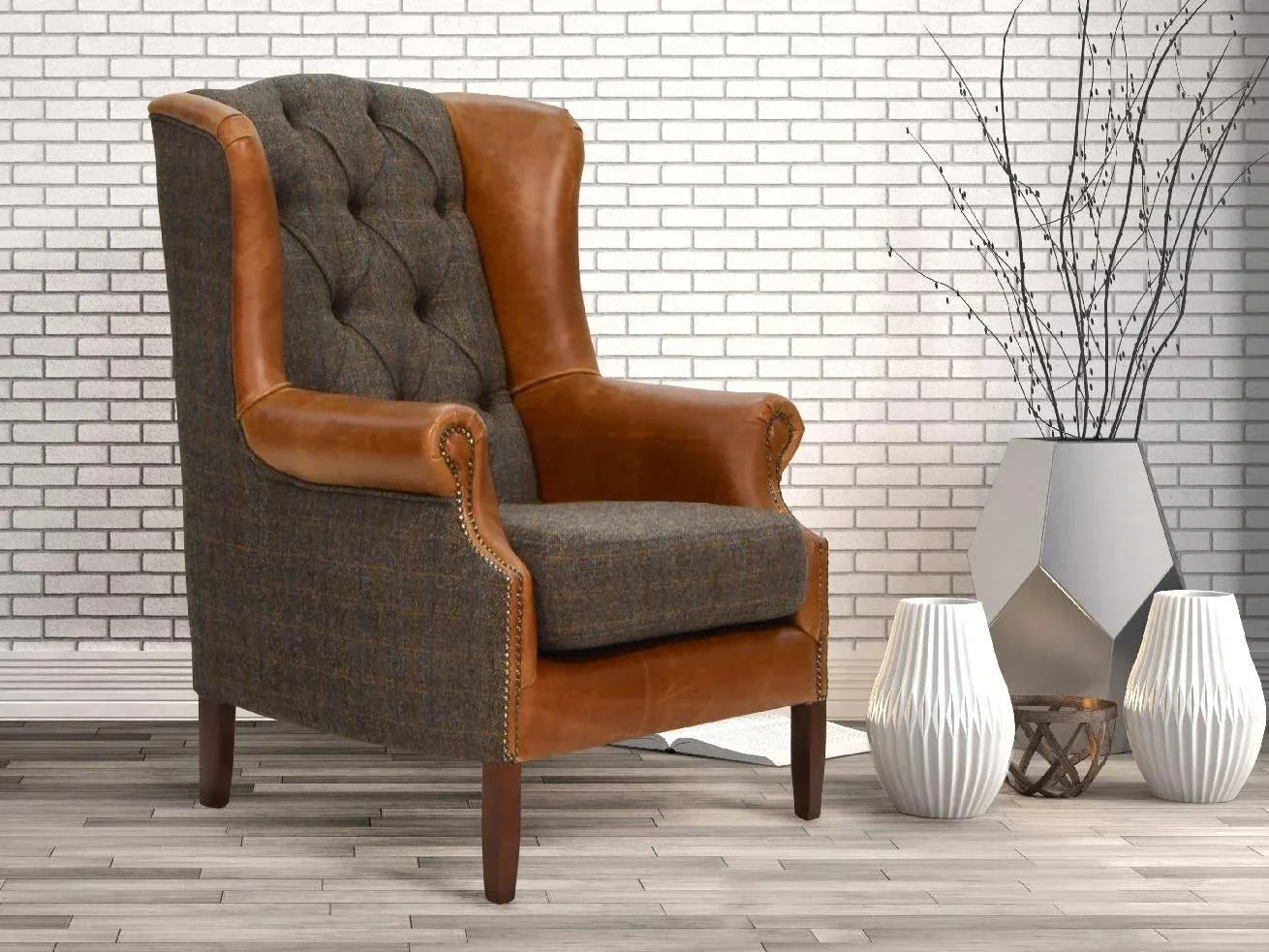 Brown leather and grey fabric armchair with button tufting in modern living room setting