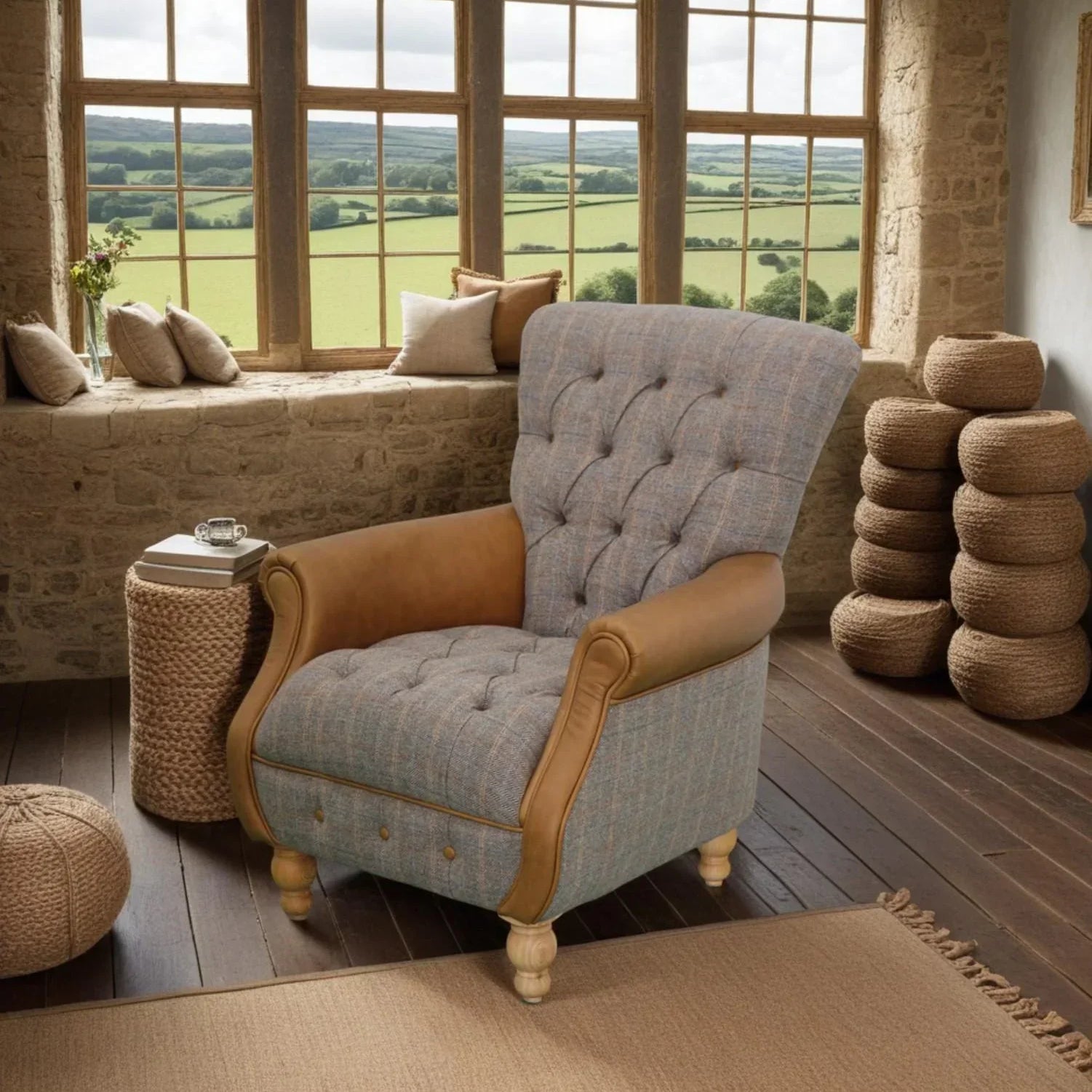 Tufted fabric armchair with leather accents in rustic living room with countryside view