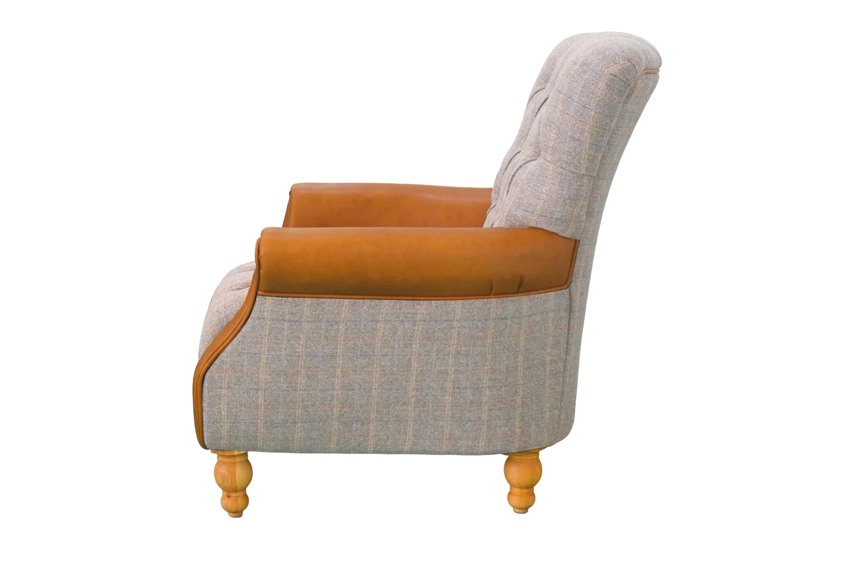Grey fabric armchair with tan leather armrests and light wood legs, side profile view