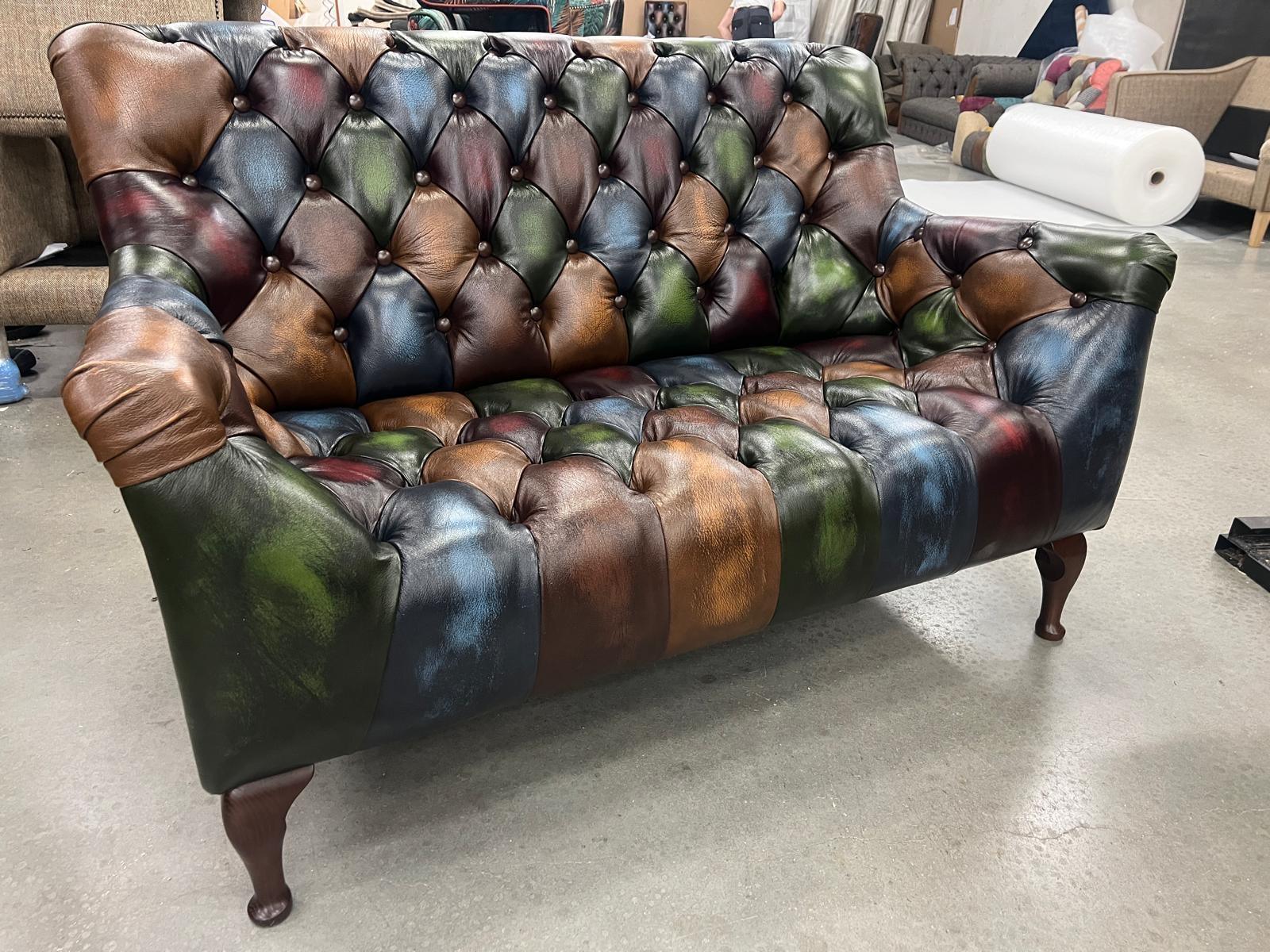 Multicolour leather chesterfield sofa with button-tufted backrest and wooden legs