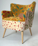 Upholstered armchair with yellow floral pattern and polka dot seat, wooden legs