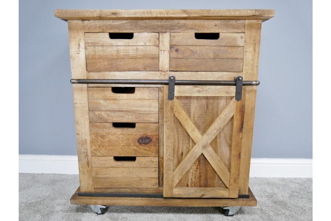 This rustic cabinet features a natural wood finish, two top drawers, three lower drawers, and a sliding barn-style door with an X design, all mounted on wheels for mobility