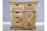 This rustic cabinet features a natural wood finish, two top drawers, three lower drawers, and a sliding barn-style door with an X design, all mounted on wheels for mobility