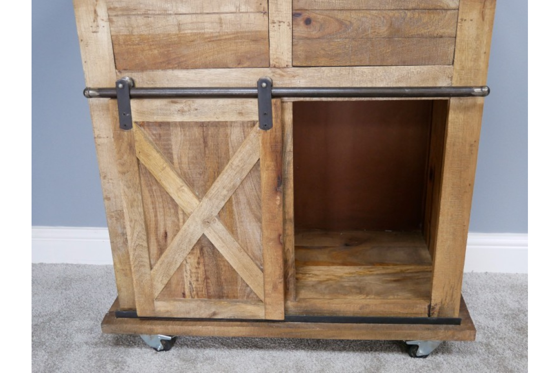 This rustic cabinet features a wooden design with a sliding barn door, showcasing a spacious interior and a sturdy base on wheels for easy mobility
