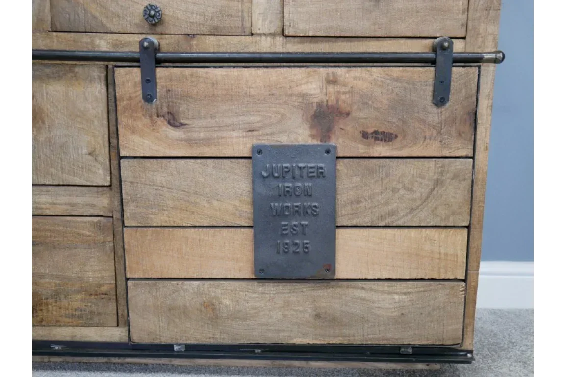 Rustic wooden sideboard with black iron handle and metal plaque detail