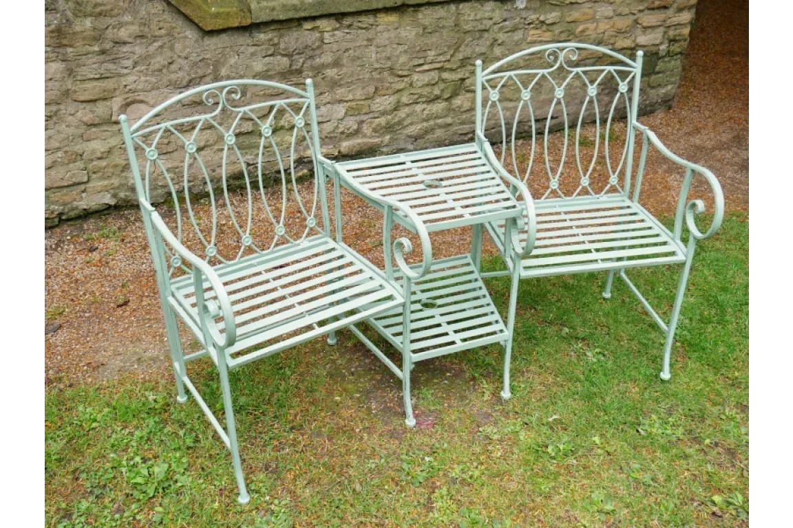 metal garden bistro set with two chairs and side table, pale green finish, on grass