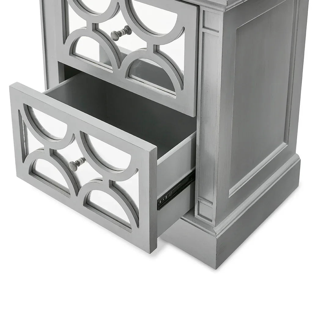 Silver bedside cabinet with mirrored drawer fronts and geometric cutout detail
