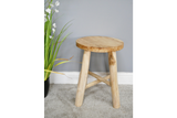 Round wooden stool with three thick legs and a cross support, shown at slight angle on gray carpet.