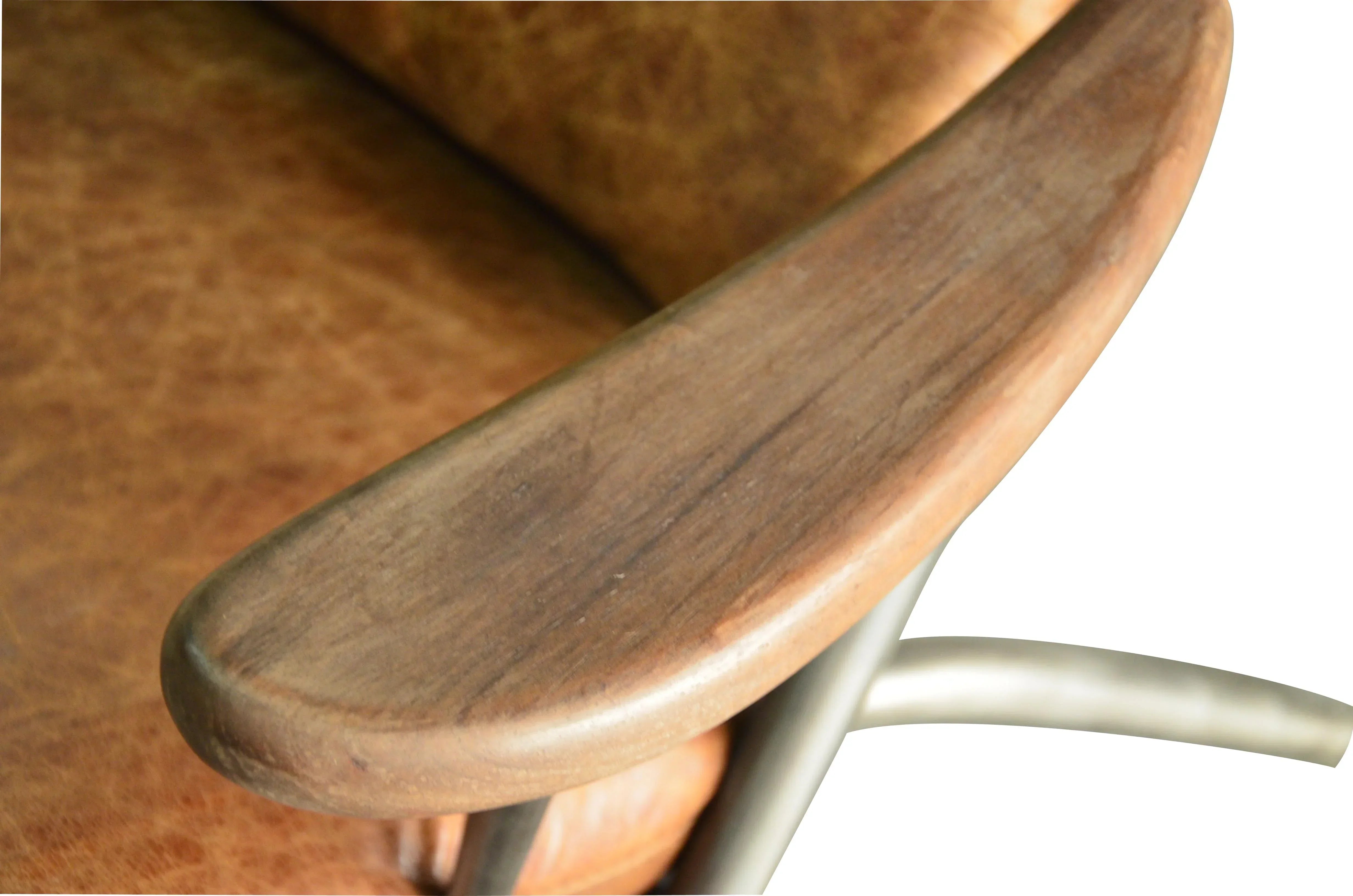 Close-up of wooden armrest on brown leather chair with metal frame