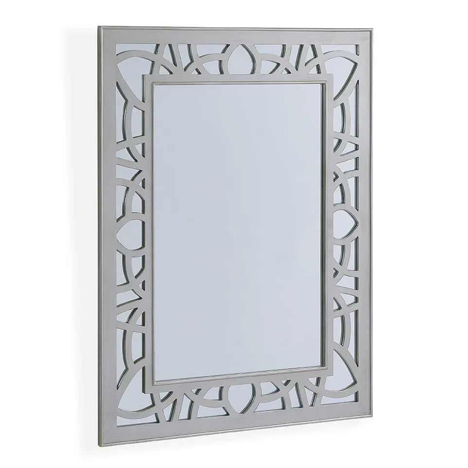 Rectangular wall mirror with silver geometric cut out frame, angled side view