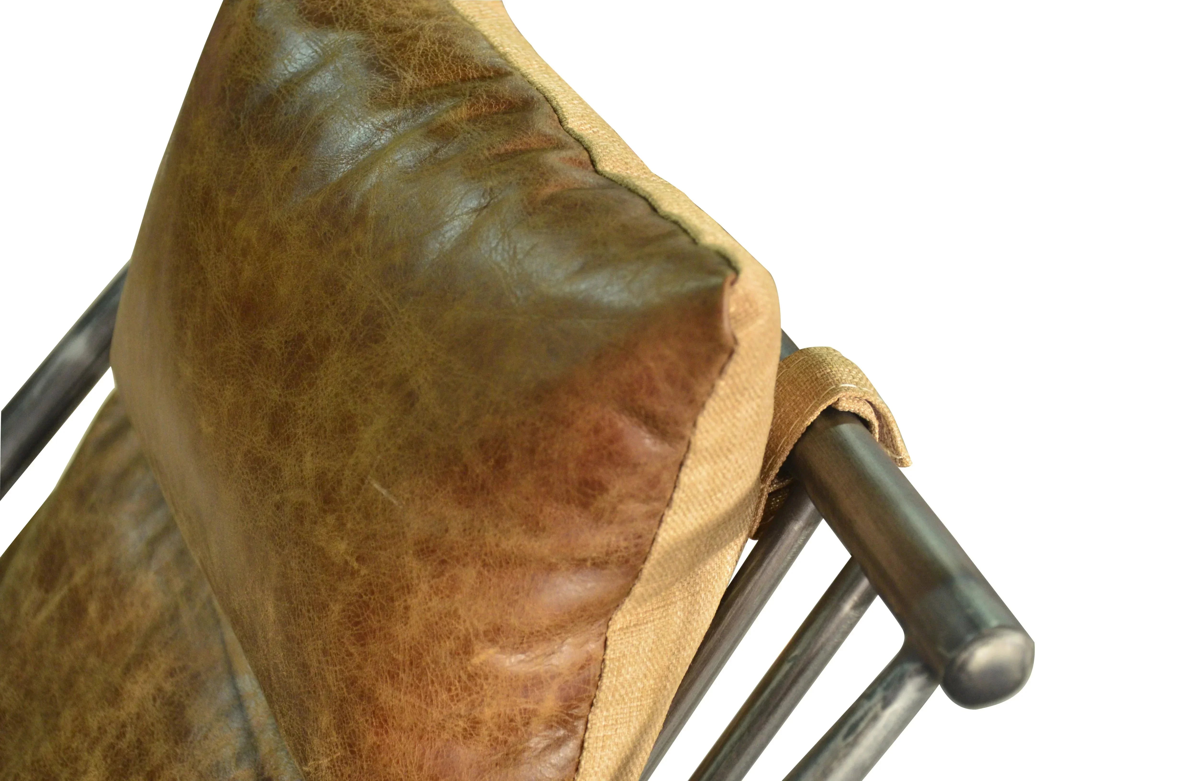 Brown leather cushion on metal chair frame, close-up of furniture upholstery and texture